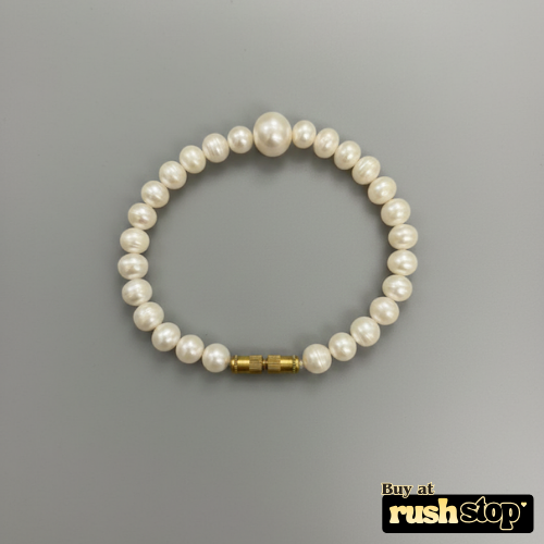 Artisan hand-knotted natural freshwater pearl bracelet featuring a prominent central Baroque pearl and gold-toned barrel clasp.