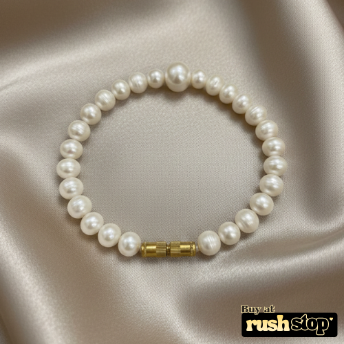 Artisan hand-knotted natural freshwater pearl bracelet featuring a prominent central Baroque pearl and gold-toned barrel clasp.