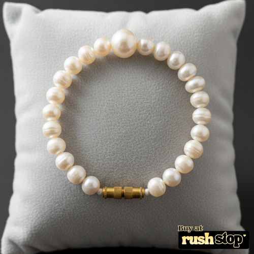 Artisan hand-knotted natural freshwater pearl bracelet featuring a prominent central Baroque pearl and gold-toned barrel clasp.