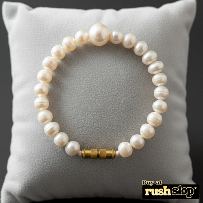 Artisan hand-knotted natural freshwater pearl bracelet featuring a prominent central Baroque pearl and gold-toned barrel clasp.