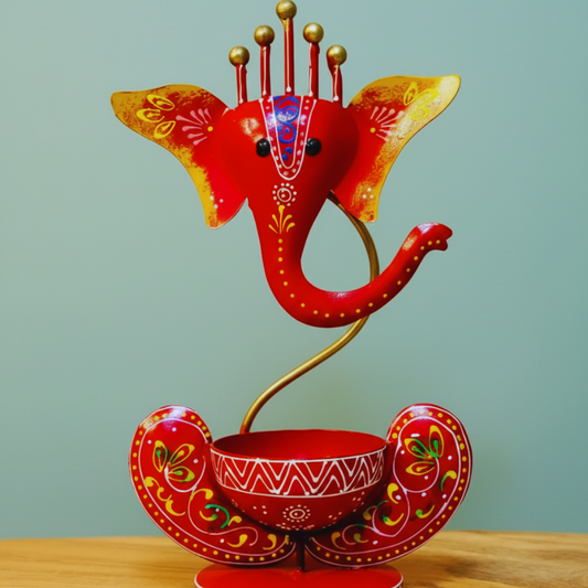 Decorative red elephant figurine with gold accents on a light green background