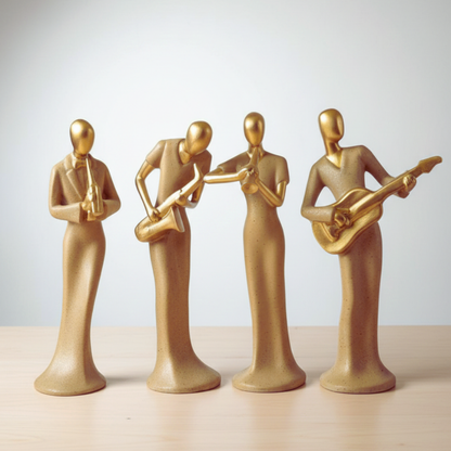 Four gold-colored musical instrument figurines on a light background
