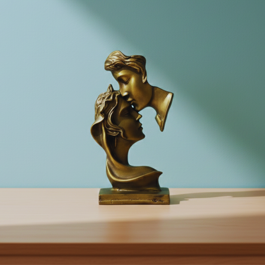 Bronze sculpture of two faces on a wooden surface with a gradient blue background