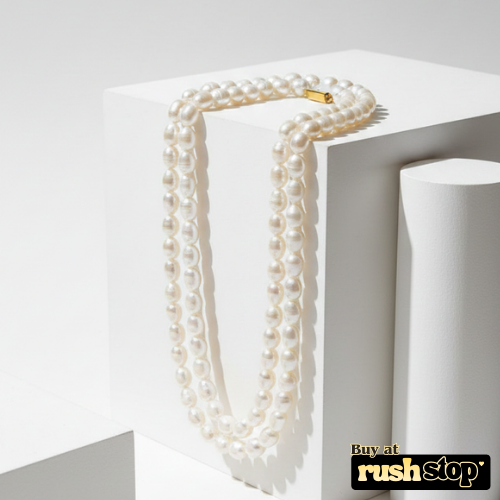 Luminous multi-strand freshwater pearl necklace with hand-selected high-luster pearls and gold-toned statement clasp.