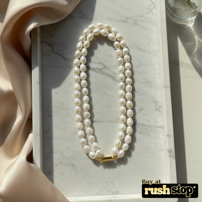 Luminous multi-strand freshwater pearl necklace with hand-selected high-luster pearls and gold-toned statement clasp.
