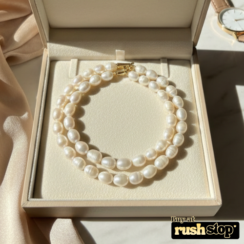 Luminous multi-strand freshwater pearl necklace with hand-selected high-luster pearls and gold-toned statement clasp.