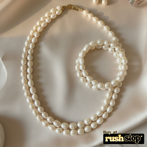 Luminous multi-strand freshwater pearl necklace with hand-selected high-luster pearls and gold-toned statement clasp.