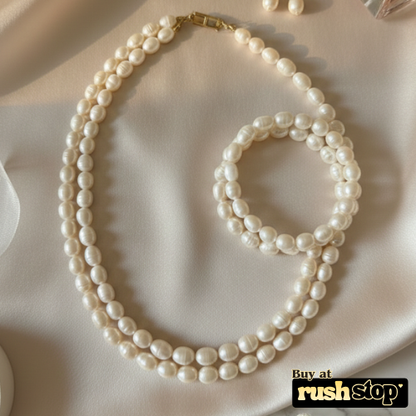 Luminous multi-strand freshwater pearl necklace with hand-selected high-luster pearls and gold-toned statement clasp.