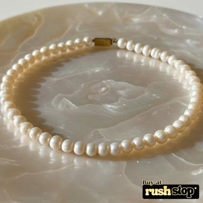 Handcrafted natural freshwater pearl necklace with creamy ivory 9mm pearls and gold-toned barrel clasp