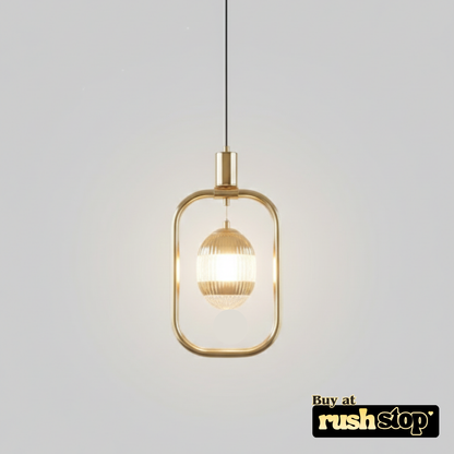Gold pendant light with glass shade on a gray background, featuring 'rushstop' branding.
