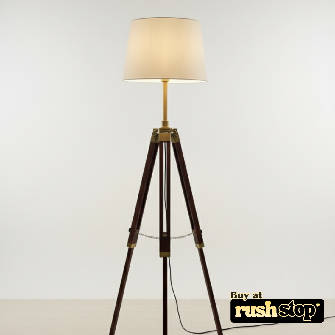 Tripod floor lamp with a beige shade on a white background, featuring 'rushstop' branding.
