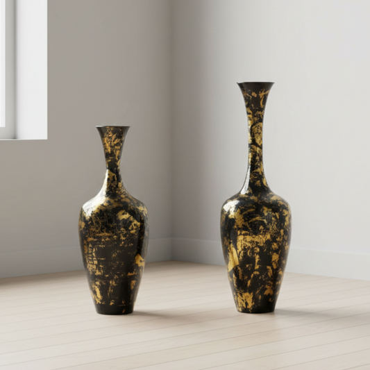 Two decorative vases with gold and black patterns on a light wooden floor.