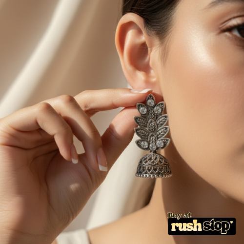 Antique oxidized silver leaf pattern jhumka earrings with crystal accents and bell shaped dangler