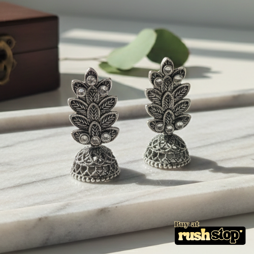 Antique oxidized silver leaf pattern jhumka earrings with crystal accents and bell shaped dangler