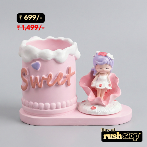 Pink decorative item with 'Sweet' text and a small figurine on a gray background, priced at 699 rupees.