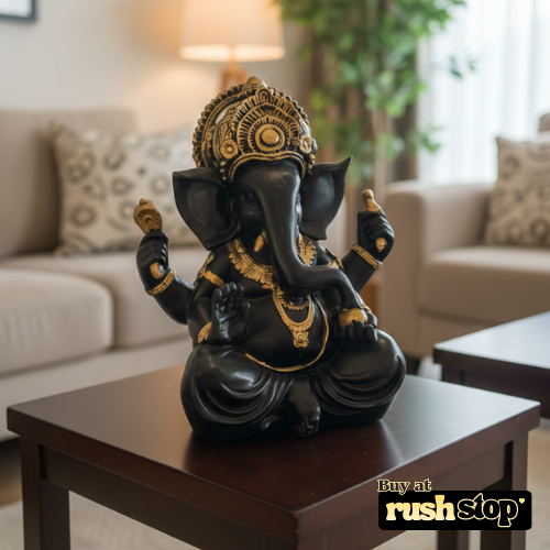 Black and gold Ganesha idol used as spiritual decor on console table