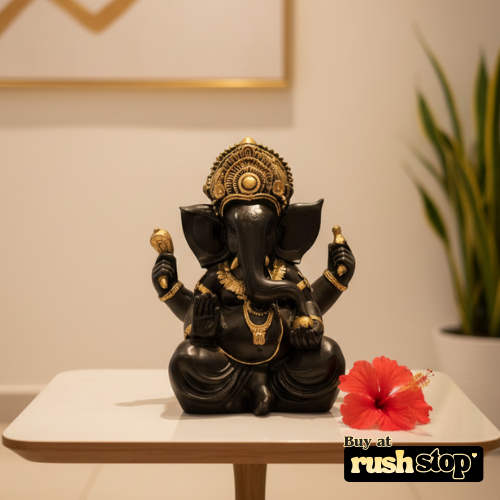 Close up of Ganesha idol showing intricate crown and antique gold jewelry details