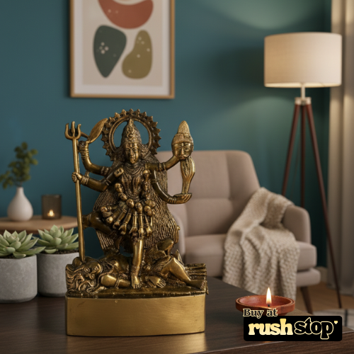 Bronze statue of a deity on a wooden table with a living room background