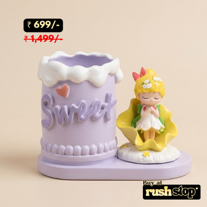 Decorative item with 'Sweet' text and a small figurine on a beige background, priced at 699/-.