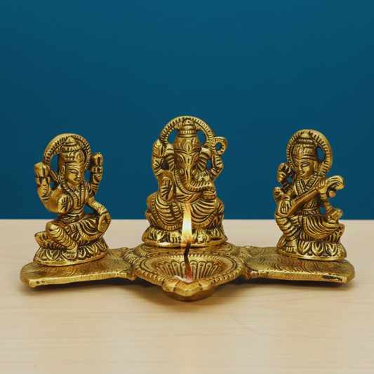 Brass lamp with three figures on a blue background