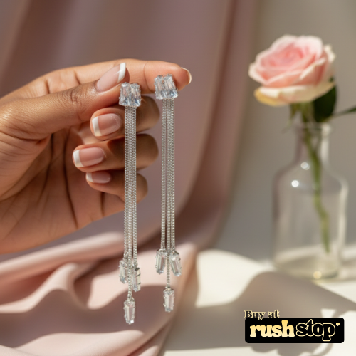 Side view of long chain crystal drop earrings in gold or silver tone with elegant movement