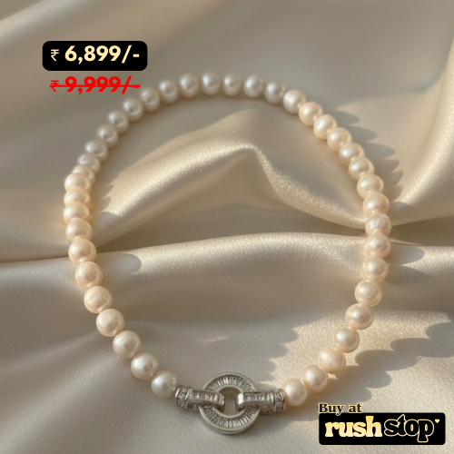 Luminous handcrafted freshwater pearl necklace with high-luster creamy white pearls and crystal-studded toggle clasp.