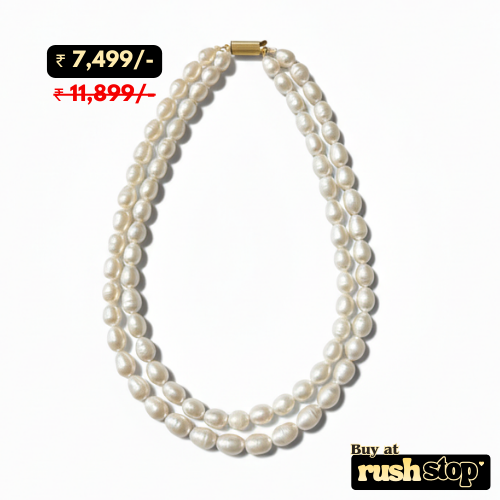 Luminous multi-strand freshwater pearl necklace with hand-selected high-luster pearls and gold-toned statement clasp.