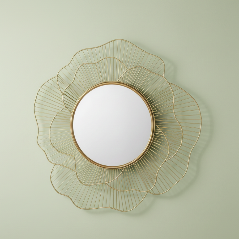 Decorative wall mirror with gold wireframe design on a light green wall