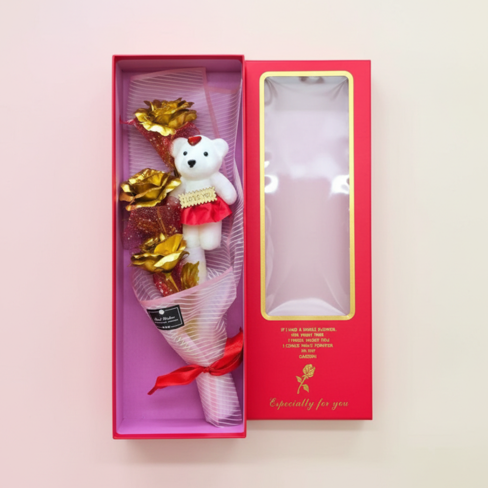 Bouquet with a teddy bear and gold leaves in a pink box on a light pink background
