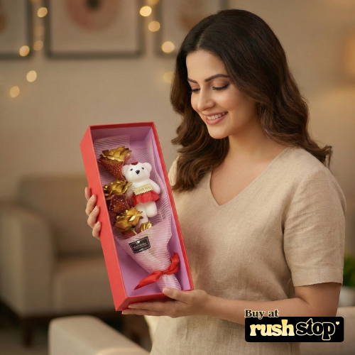Woman holding a gift box with a teddy bear and chocolate flowers, blurred background