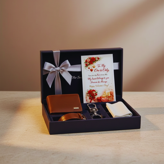 Gift set with wallet, keychain, and card in a box on a wooden surface.