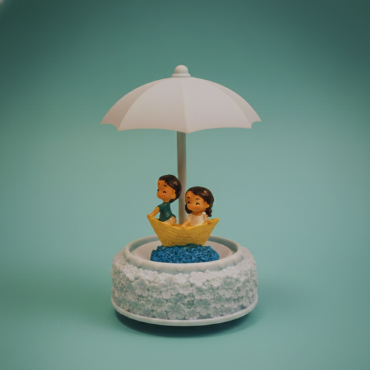 Decorative figurine with two people under an umbrella on a blue background