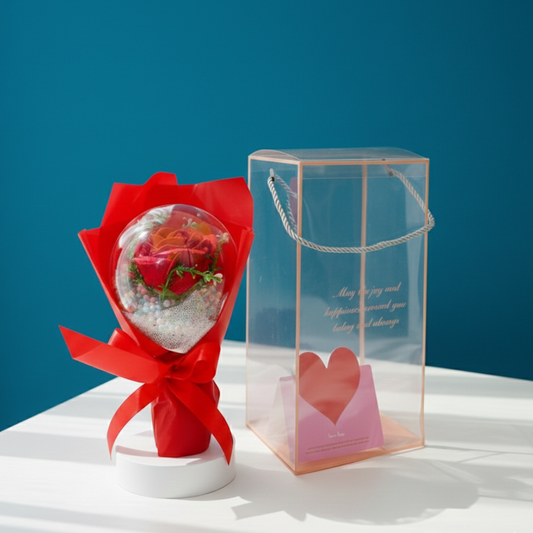 Bouquet of red roses in a transparent box with a heart design on a blue background
