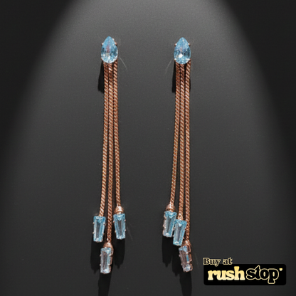 Rose gold multi chain crystal dangle earrings with blue and clear baguette crystals