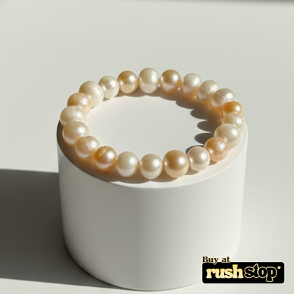 Handcrafted white and peach freshwater pearl bracelet with baroque center