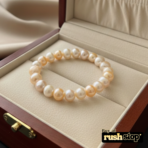 Handcrafted white and peach freshwater pearl bracelet with baroque center