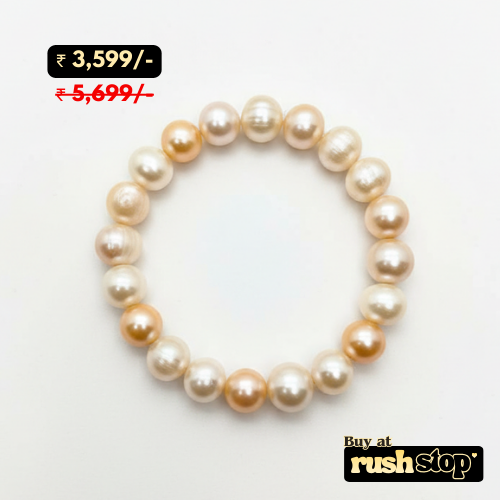 Handcrafted white and peach freshwater pearl bracelet with baroque center