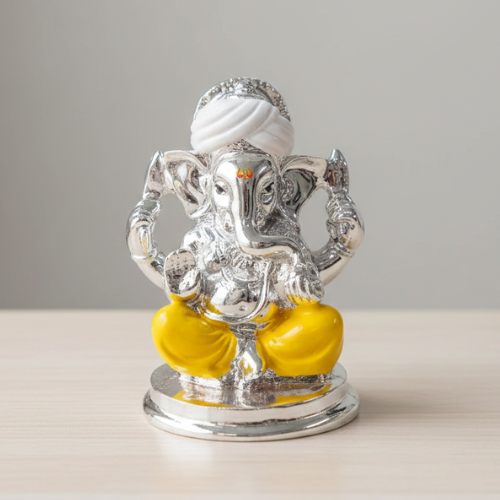 Silver and yellow elephant statue on a plain background