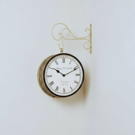 Vintage-style wall clock with decorative bracket on a light background