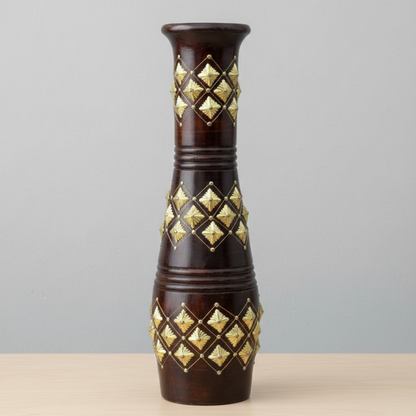 Decorative vase with gold geometric patterns on a gray background