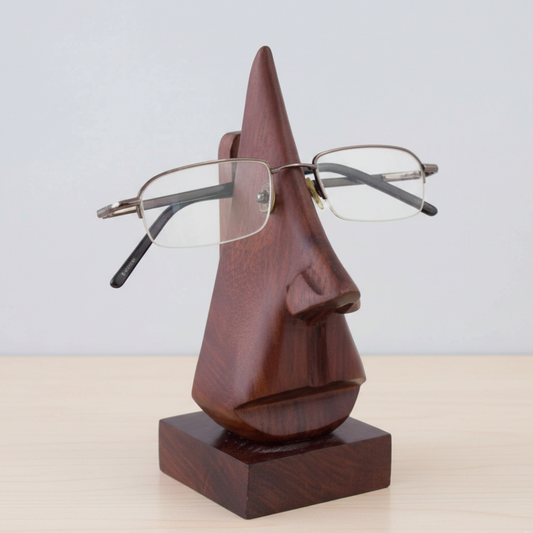 Wooden sculpture of a face with glasses on a white background