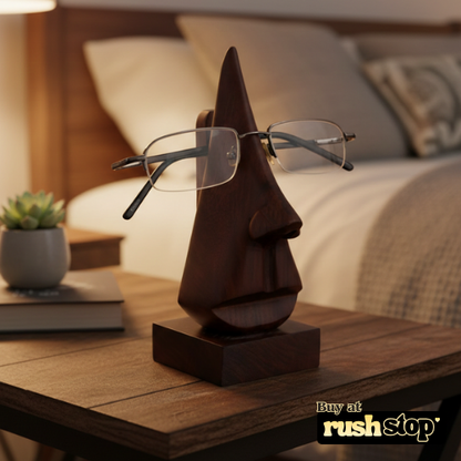 Wooden sculpture of a face with glasses on a table, with 'rushstop' branding.